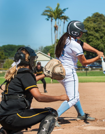 White uniform fast pitch softball batter